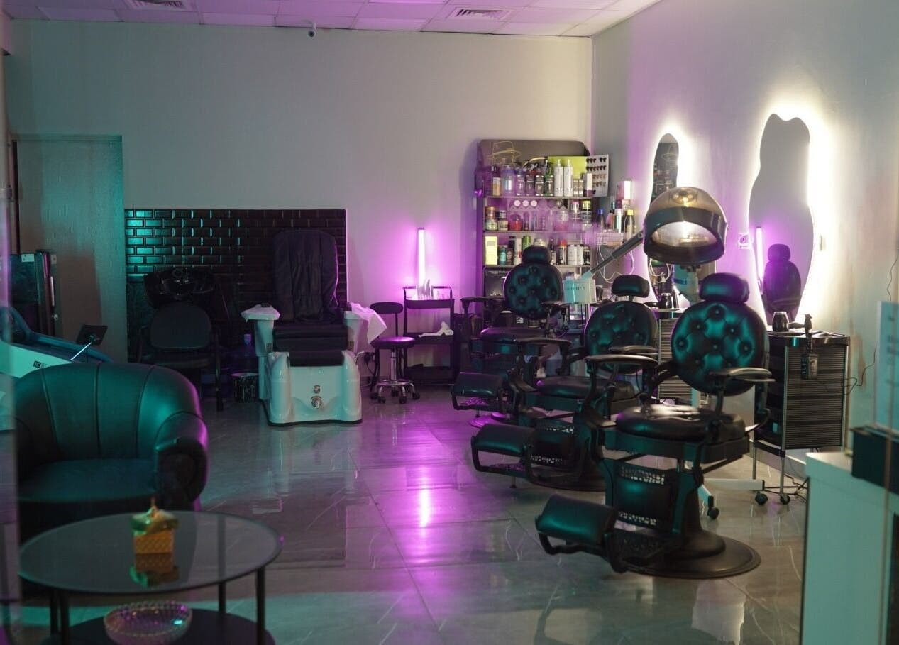 Luxurious interior of Glowing Gents Salon and SPA with modern chairs and ambient lighting, Dubai, AE.