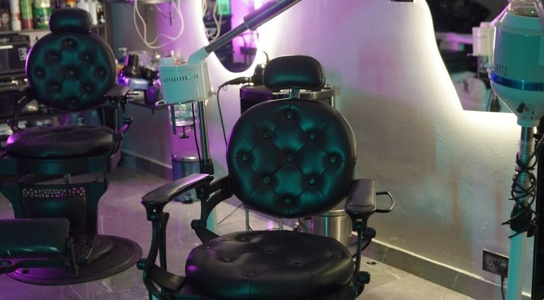 Luxurious barber chairs at Glowing Gents Salon and SPA in Dubai, AE, featuring modern equipment.