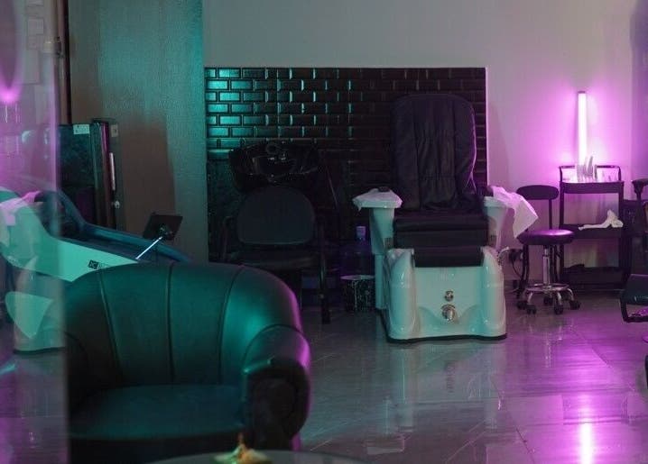 Glowing Gents Salon and SPA in Dubai, AE features a serene, modern interior with purple ambient lighting.