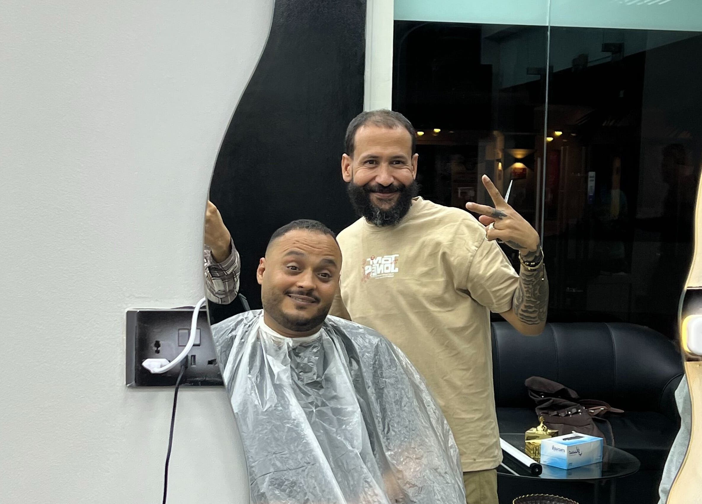 A happy customer receiving a haircut at Glowing Gents Salon and SPA, Dubai, AE.
