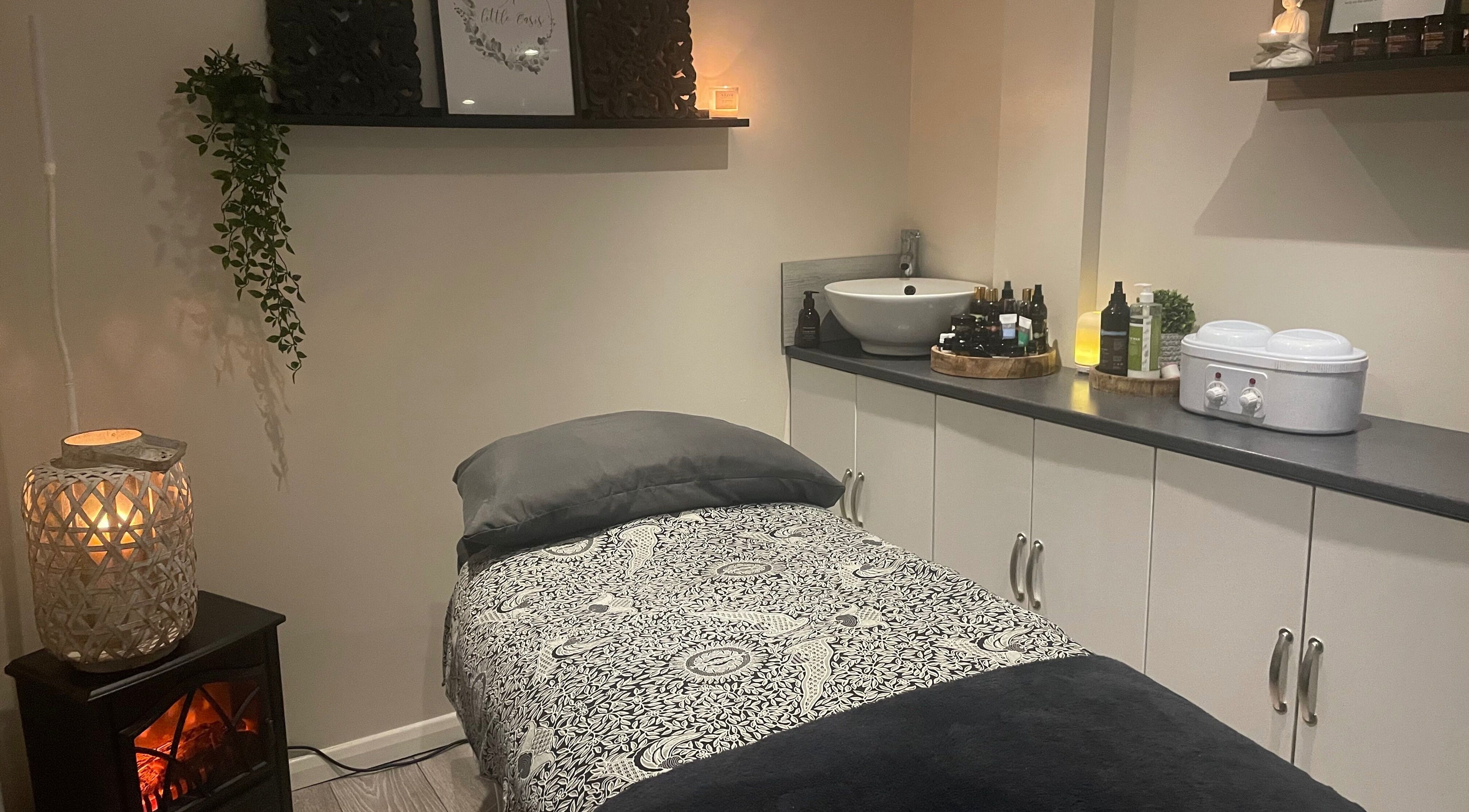 A relaxing treatment room at A Little Oasis, Ipswich, England, GB with ambient lighting and soothing decor.