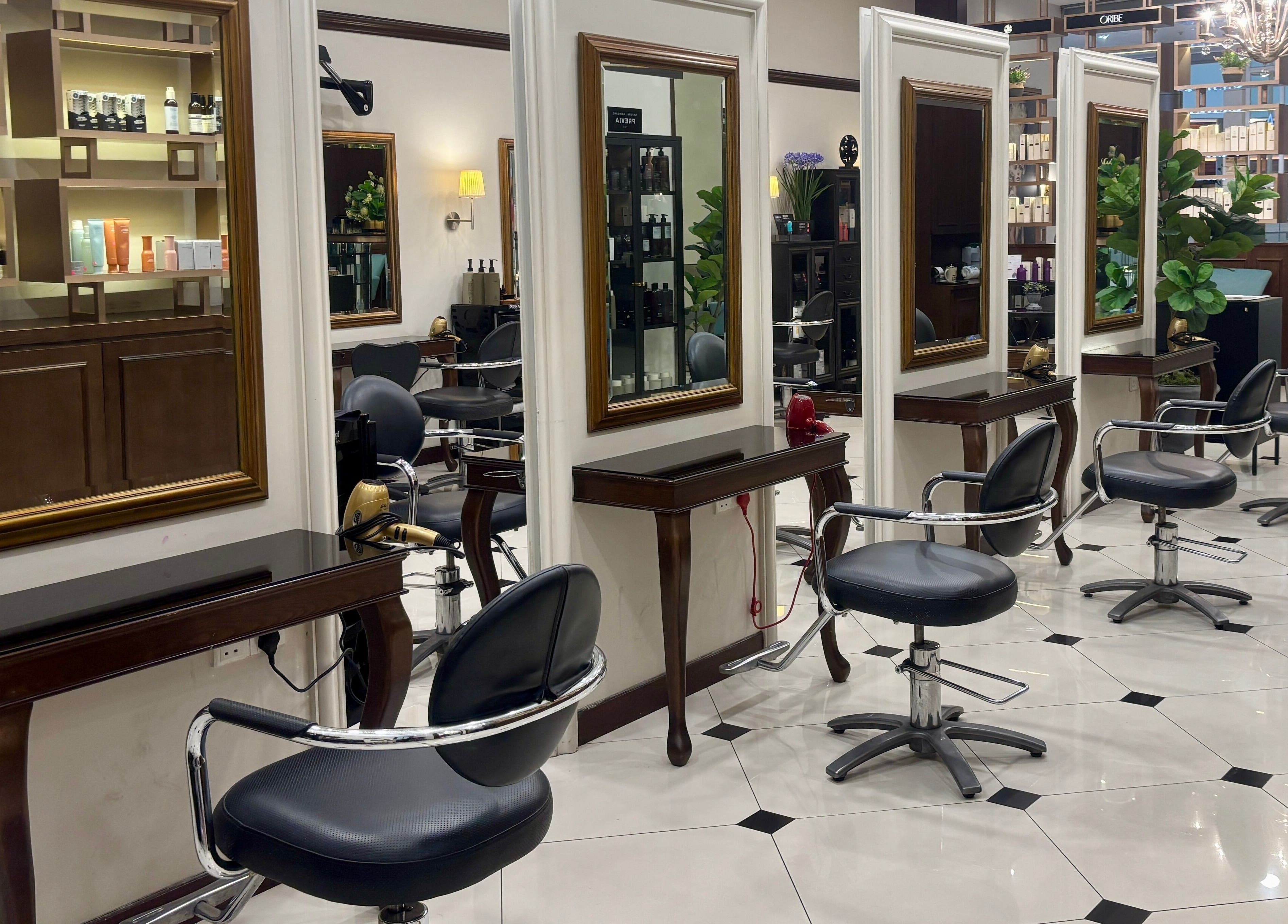 Luxurious interior of Andy Ho Haute Coiffure, Kuala Lumpur, MY, showcasing elegant styling chairs and mirrors.