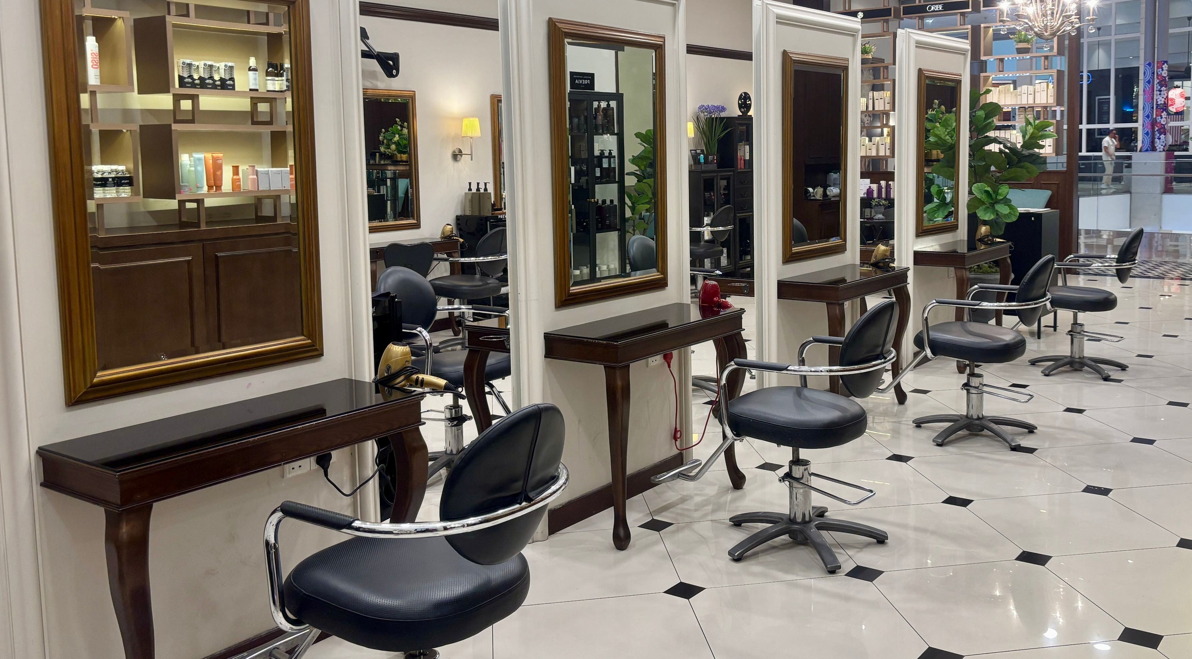 Luxurious interior of Andy Ho Haute Coiffure, Kuala Lumpur, MY, showcasing elegant styling chairs and mirrors.