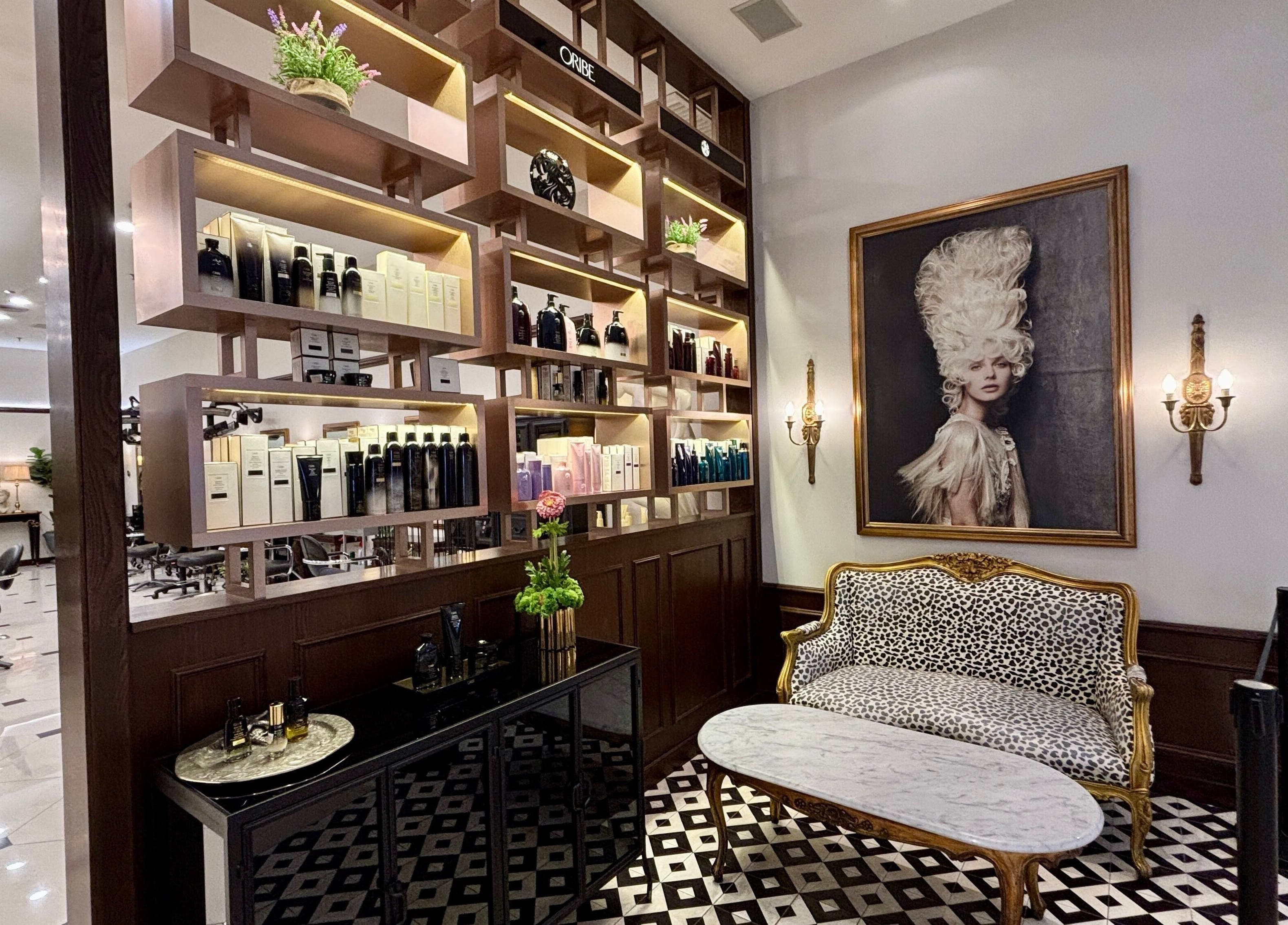 Chic interior of Andy Ho Haute Coiffure, Kuala Lumpur, showcasing luxury seating and beauty products.