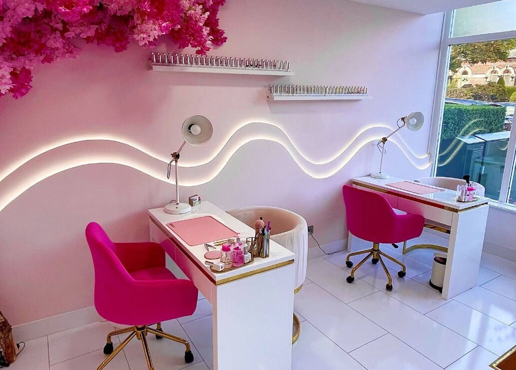 Chic nail station at Nails By Ash, East Boldon, England, GB with pink chairs and floral decor.