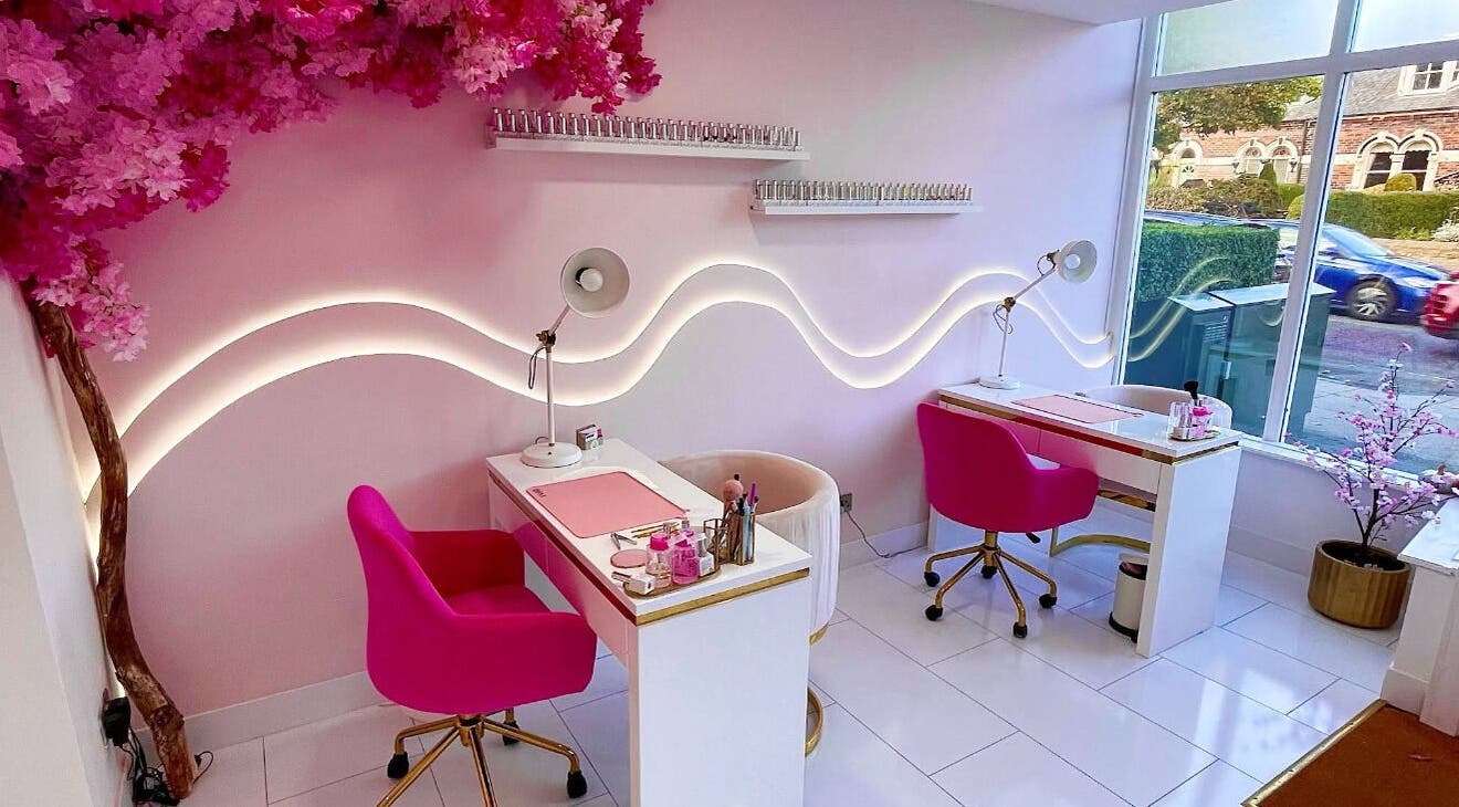 Chic nail station at Nails By Ash, East Boldon, England, GB with pink chairs and floral decor.