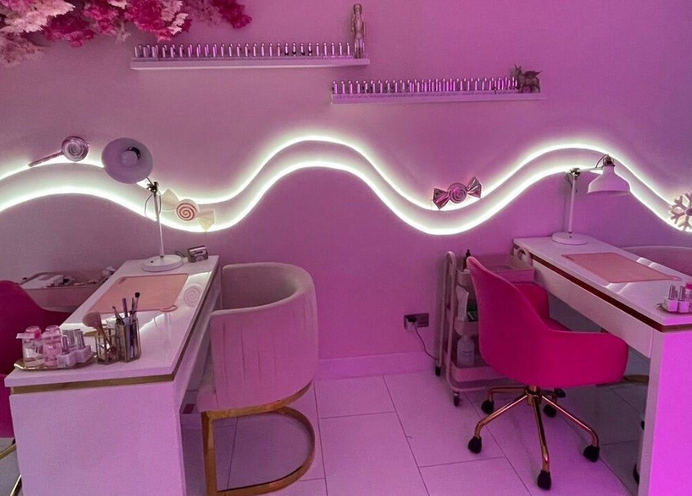 Elegant nail salon interior at Nails By Ash, East Boldon, England, GB, featuring chic pink decor and cozy seating.