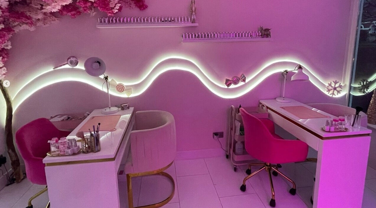 Elegant nail salon interior at Nails By Ash, East Boldon, England, GB, featuring chic pink decor and cozy seating.