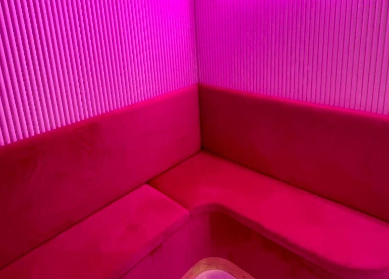 Cozy pink seating at Nails By Ash, East Boldon, England, GB, offering vibrant relaxation.