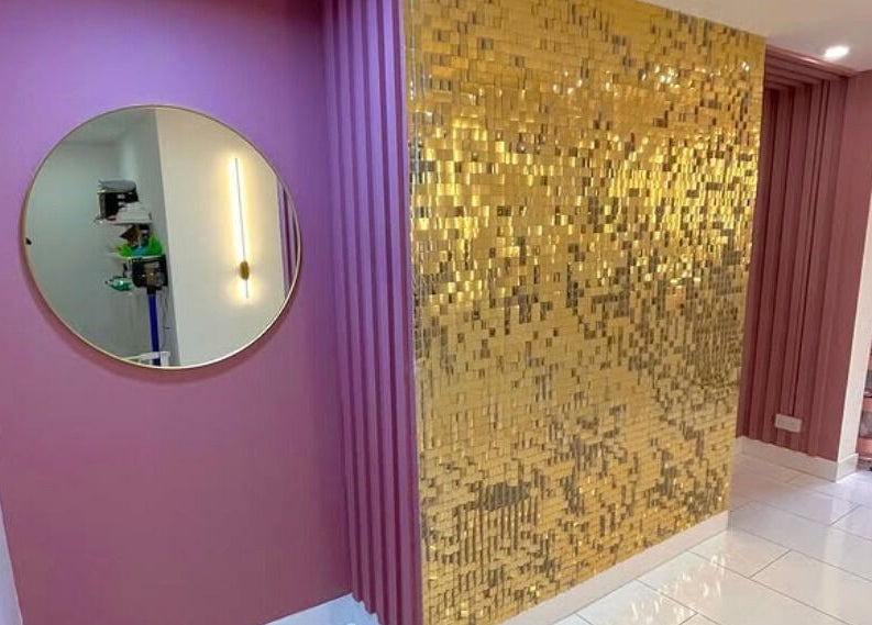 Chic interior at Nails By Ash, East Boldon, featuring gold mosaic wall and pink decor.