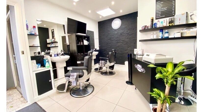 Interior of Andre’s Barber Shop, Brighton And Hove, England, featuring sleek chairs and modern decor.