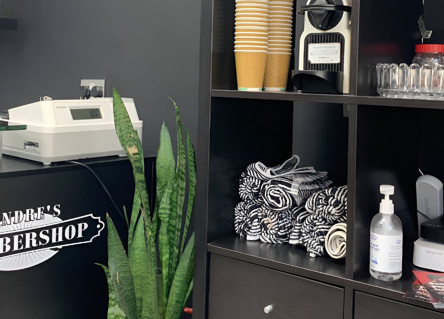 Reception of Andre’s Barber Shop in Brighton And Hove, England, featuring towels and products.