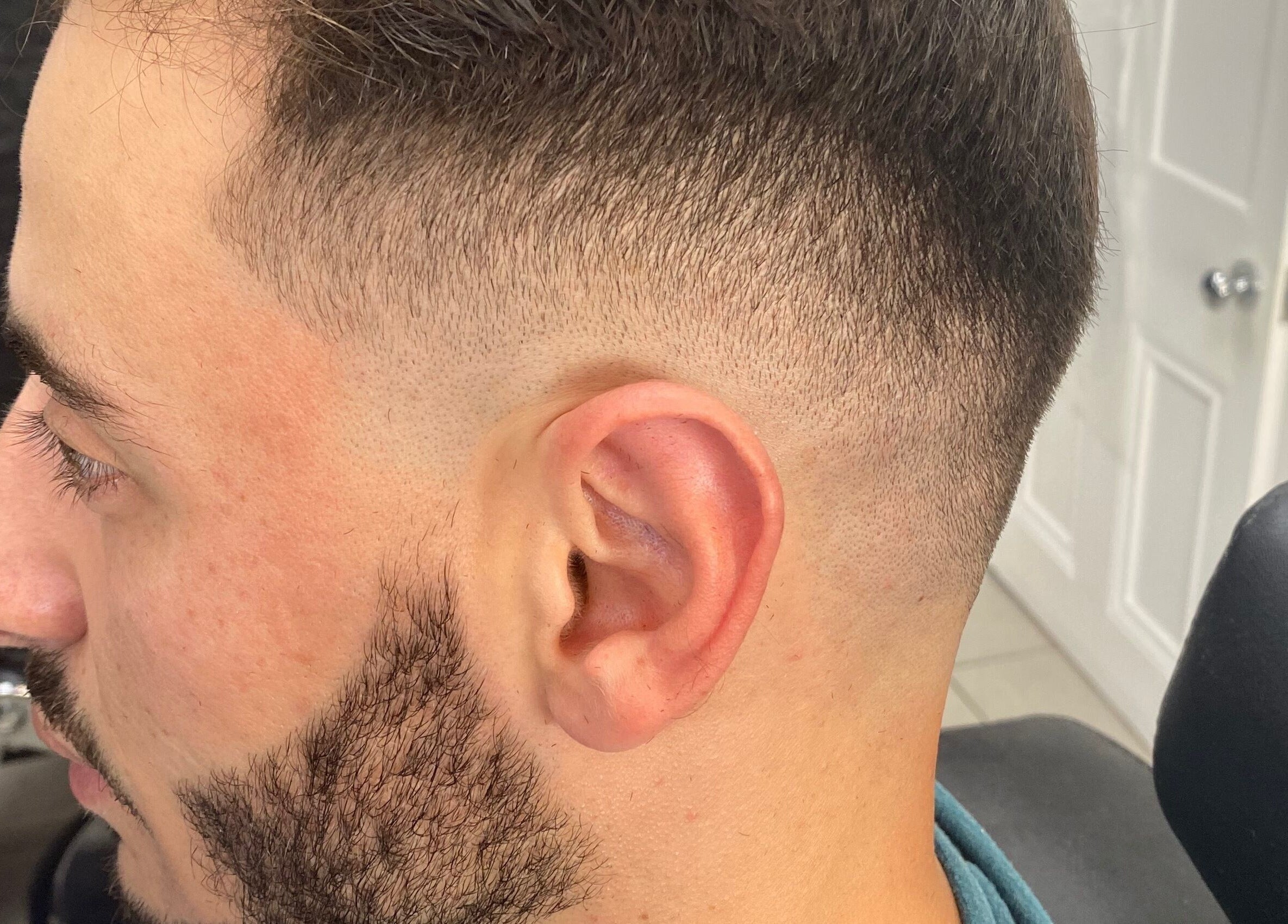 A precise fade haircut at Andre’s Barber Shop, Brighton And Hove, England, GB, showing expert barber skills.