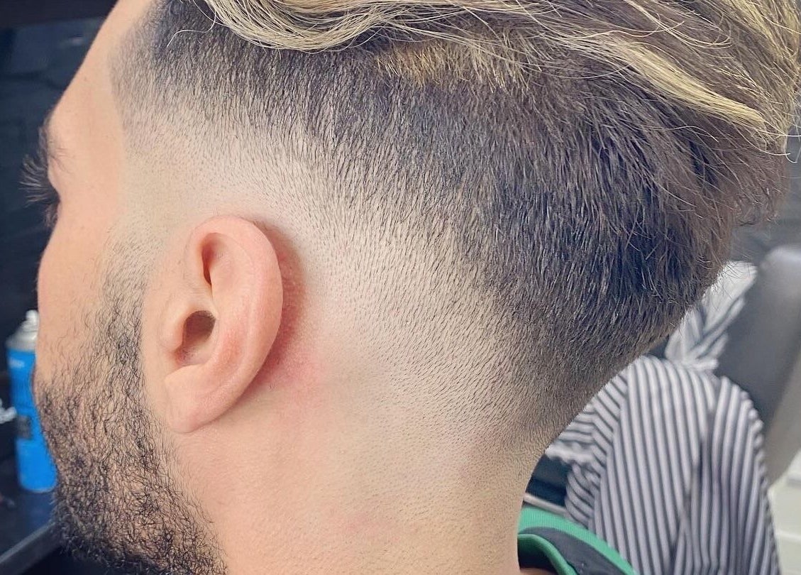 Stylish men's fade haircut at Andre’s Barber Shop, Brighton And Hove, England, GB.