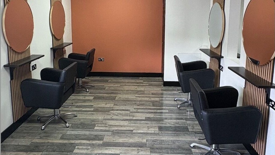 Elegant salon setup at LS Studio in Rotherham, England, GB with modern black chairs and round mirrors.
