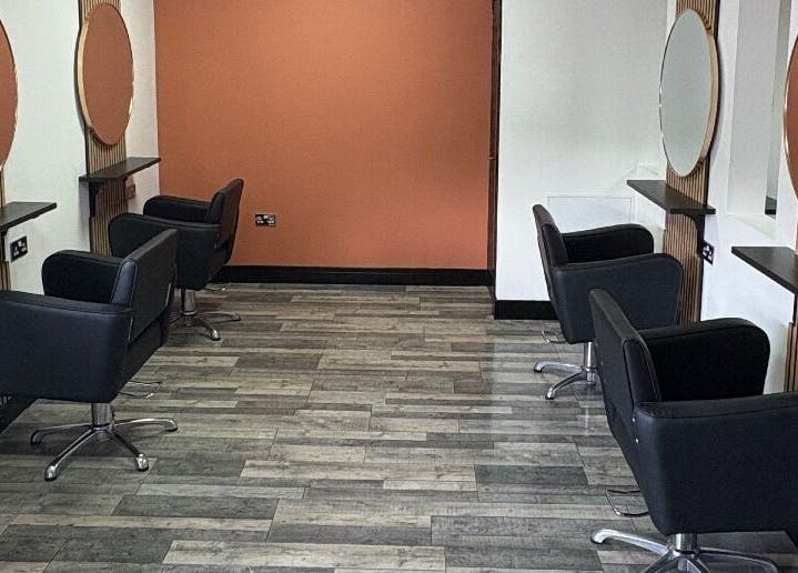 Elegant salon setup at LS Studio in Rotherham, England, GB with modern black chairs and round mirrors.