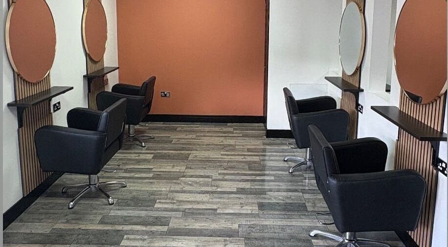 Elegant salon setup at LS Studio in Rotherham, England, GB with modern black chairs and round mirrors.