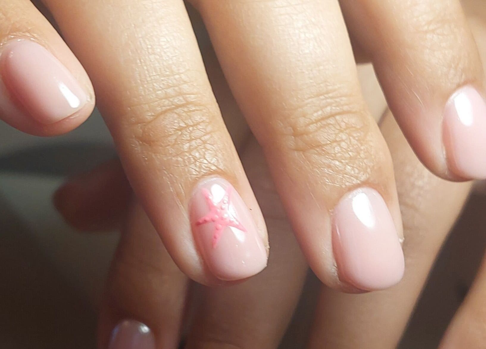 Elegant nail art at Rose & Luxe, Barvas, Scotland featuring a soft pink design with subtle accents.