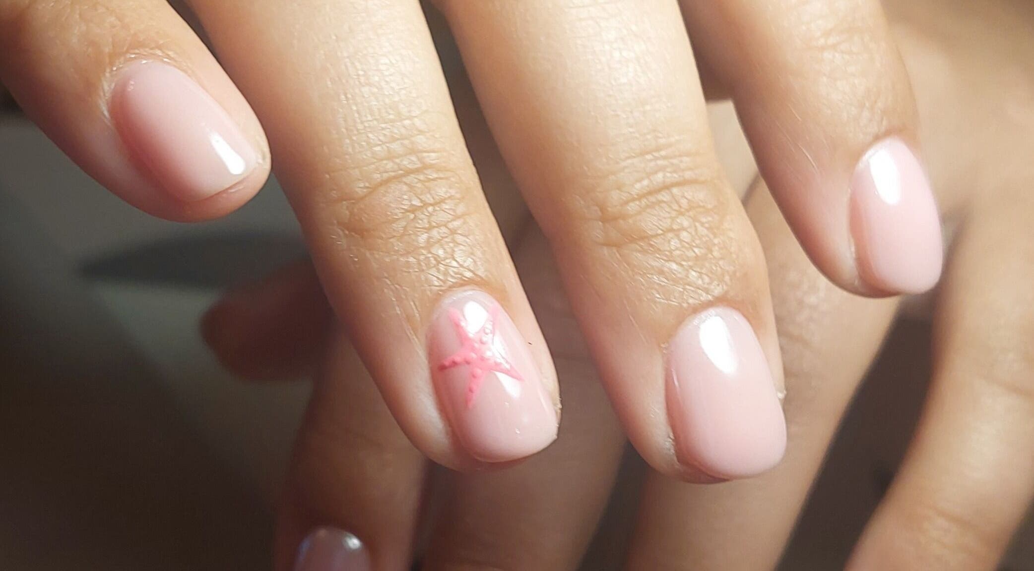 Elegant nail art at Rose & Luxe, Barvas, Scotland featuring a soft pink design with subtle accents.