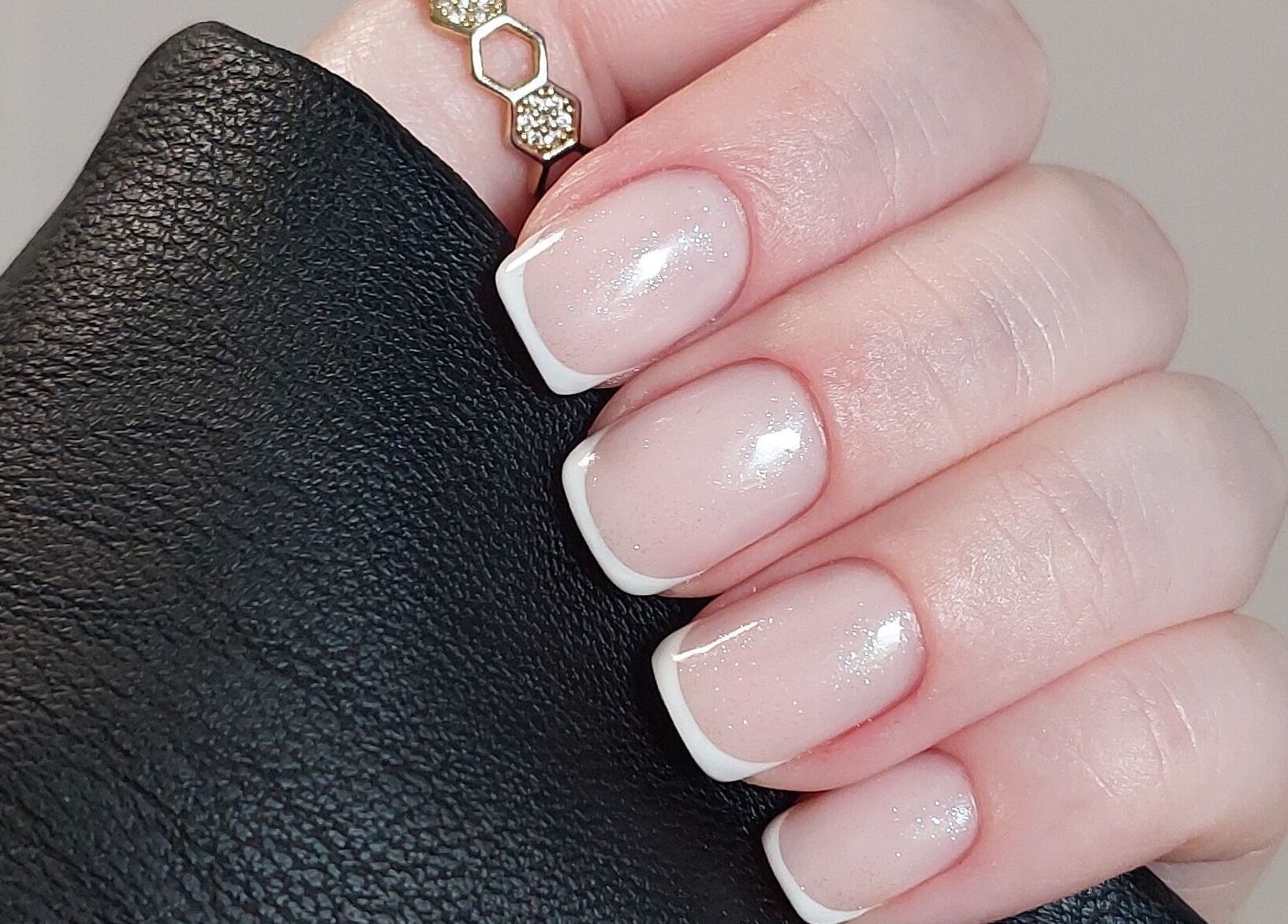 Chic French manicure at Rose & Luxe, Barvas, Scotland, GB. Perfectly polished nails with a touch of sparkle.