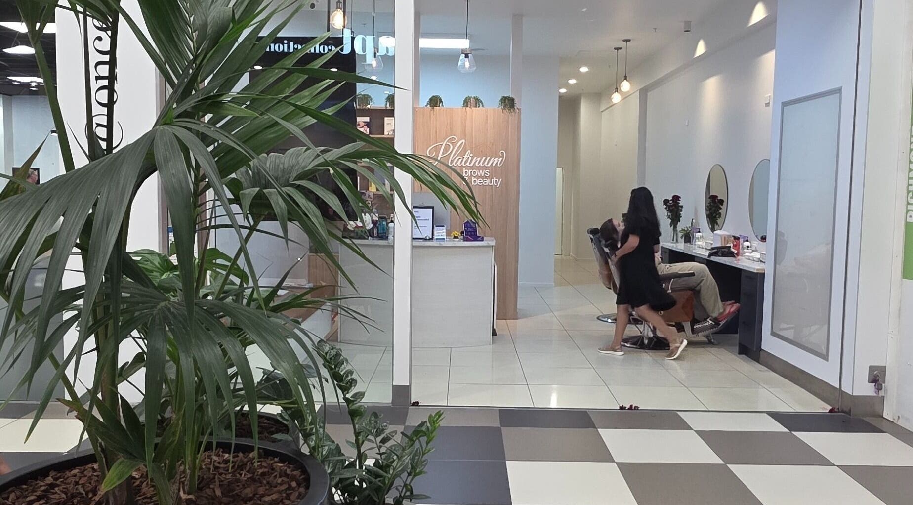 Inside Platinum Brows and Beauty in Richmond, Tasman, NZ, featuring stylish decor and a client receiving a treatment.