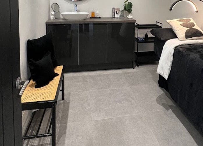 Tranquil treatment room at Lashed by Nhi in Welling, England, GB featuring a cozy bed and elegant decor.