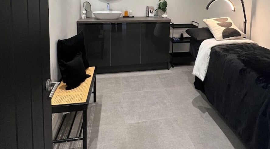 Tranquil treatment room at Lashed by Nhi in Welling, England, GB featuring a cozy bed and elegant decor.