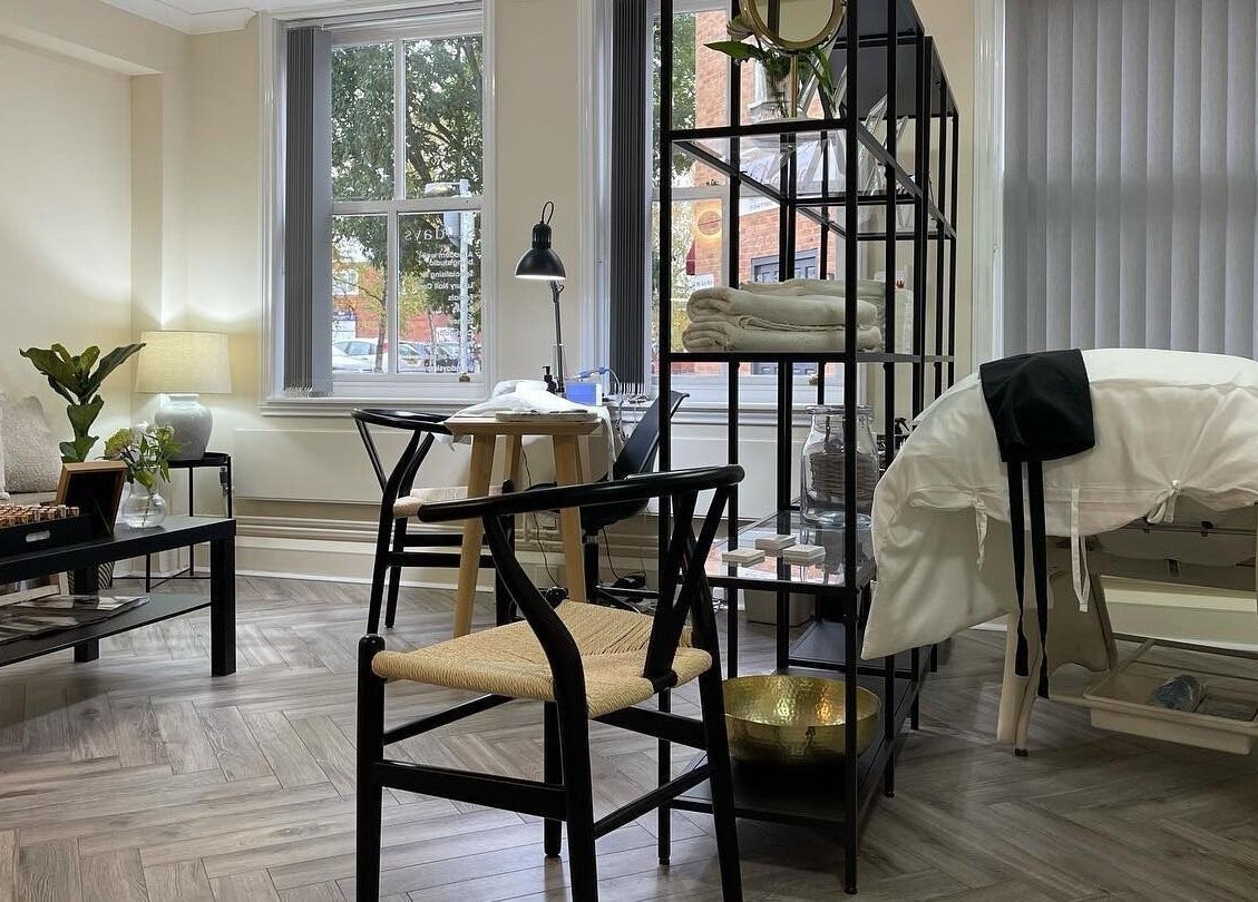 Tranquil interior of Sundays wellness center in Knowle, England, GB with a massage table and seating area.