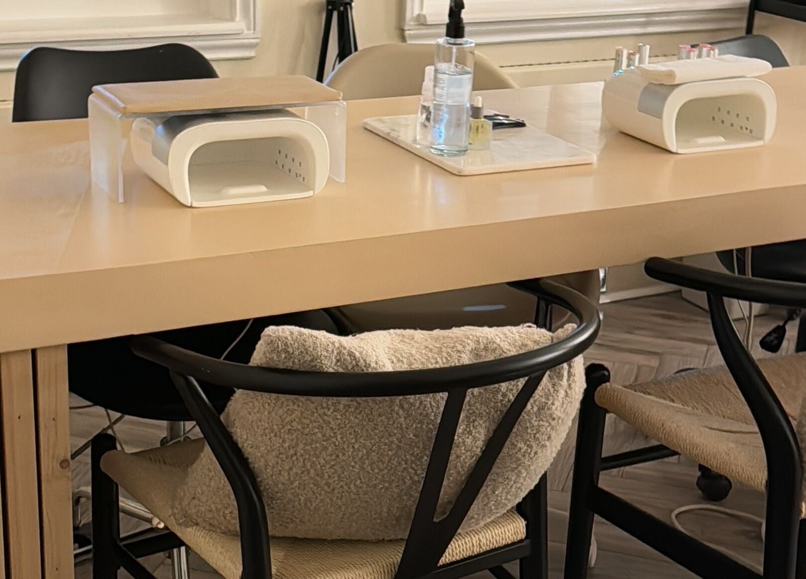 Cozy manicure station at Sundays in Knowle, England, GB, featuring modern furniture and nail care tools.