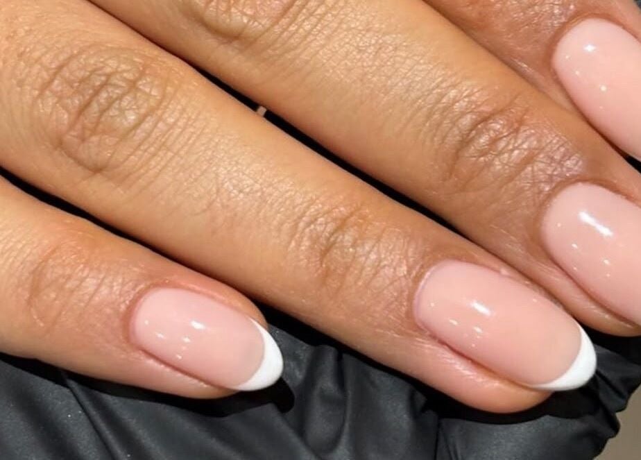 Elegant French manicure done at Sundays, Knowle, England, GB showcasing glossy, neat nails.