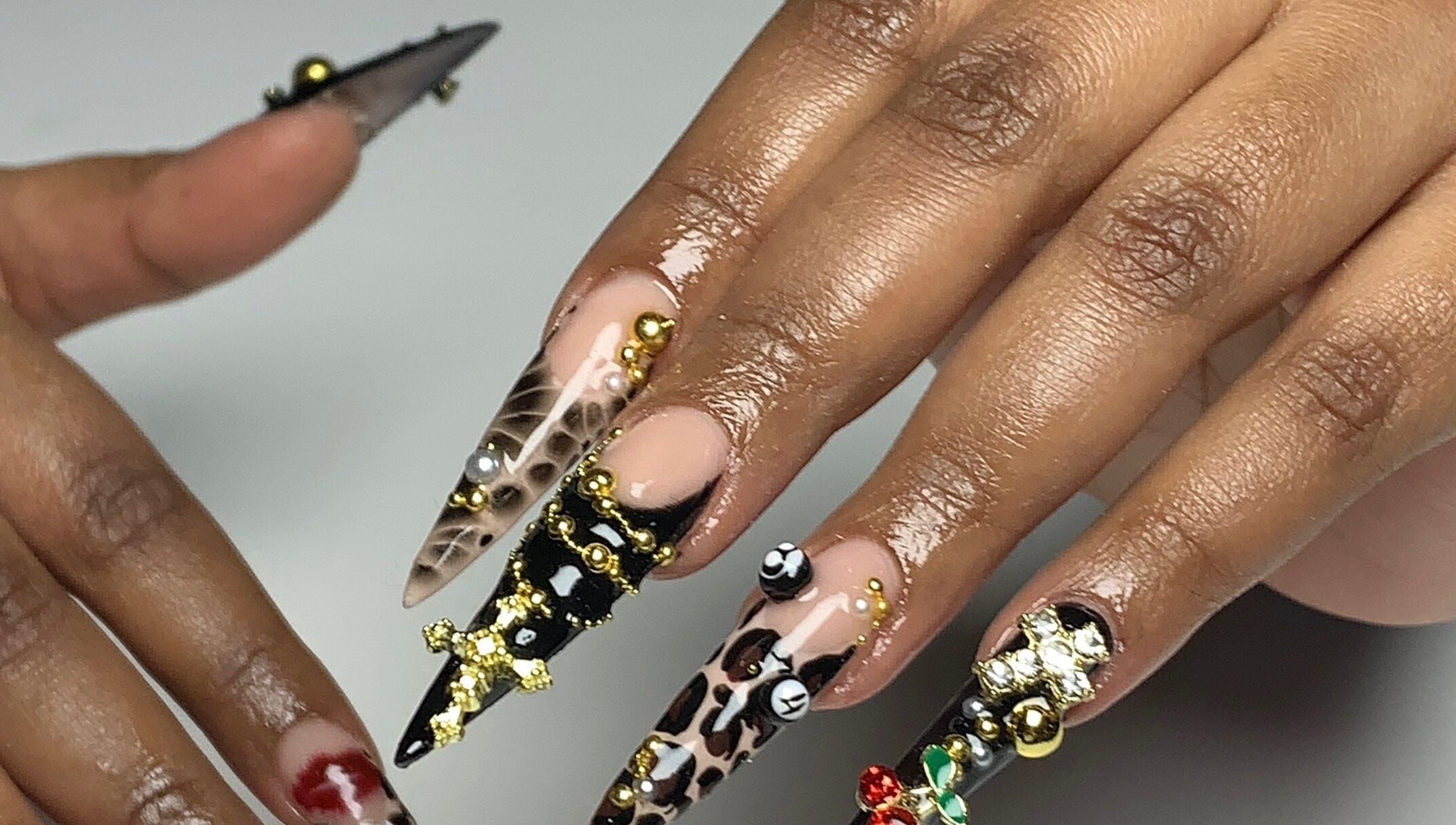 Intricate nail art designs at CLAWZ in Cape Town, Western Cape, ZA, showcasing detailed embellishments.
