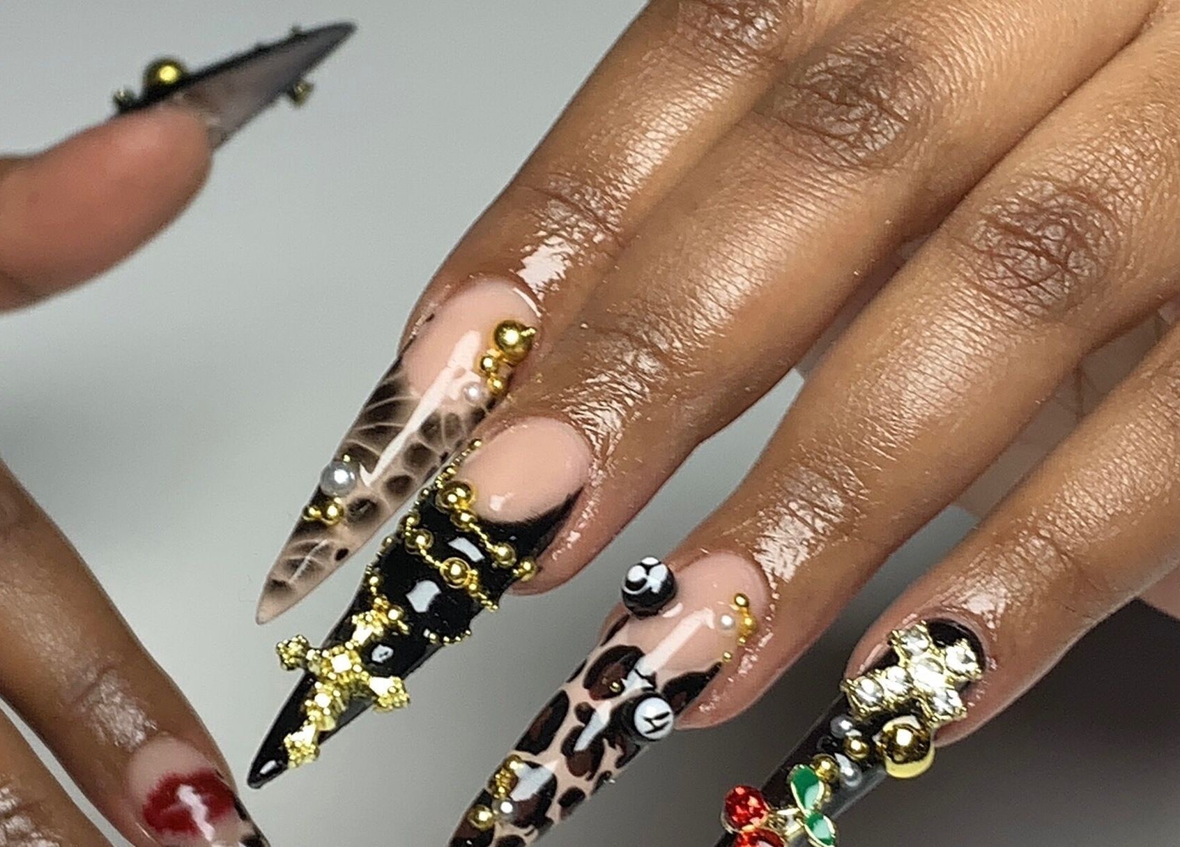 Intricate nail art designs at CLAWZ in Cape Town, Western Cape, ZA, showcasing detailed embellishments.
