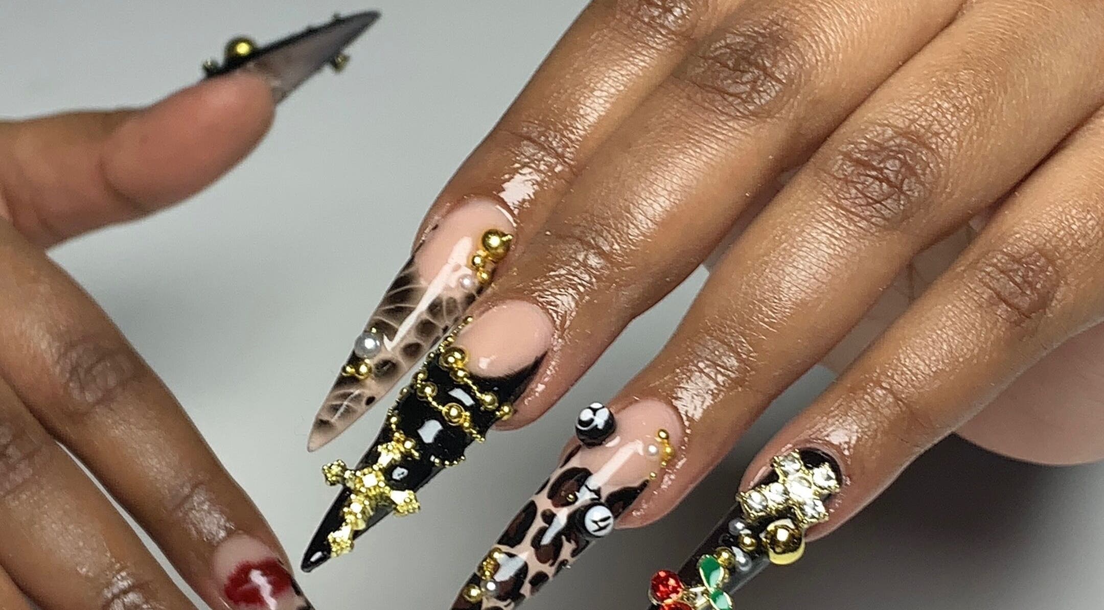 Intricate nail art designs at CLAWZ in Cape Town, Western Cape, ZA, showcasing detailed embellishments.