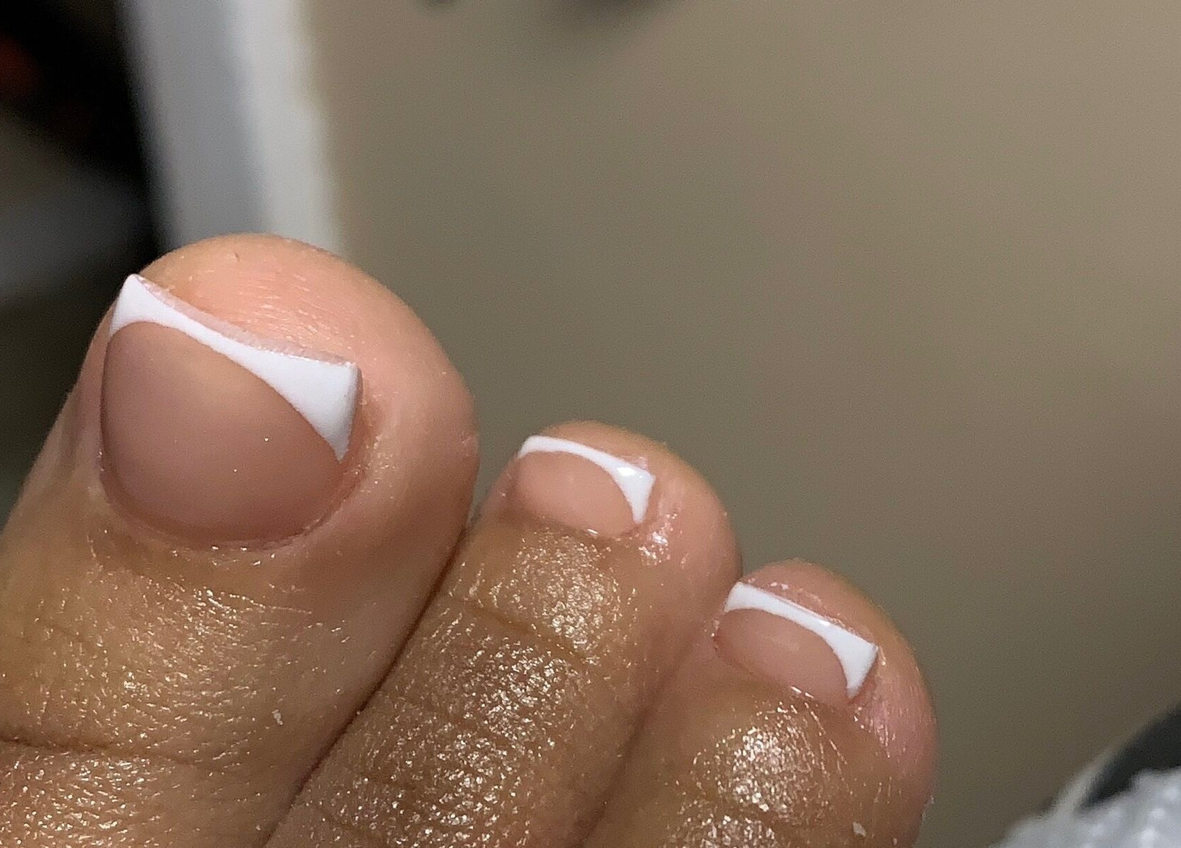 Close-up of a French pedicure at CLAWZ, Cape Town, Western Cape, ZA, showcasing neatly manicured toenails.