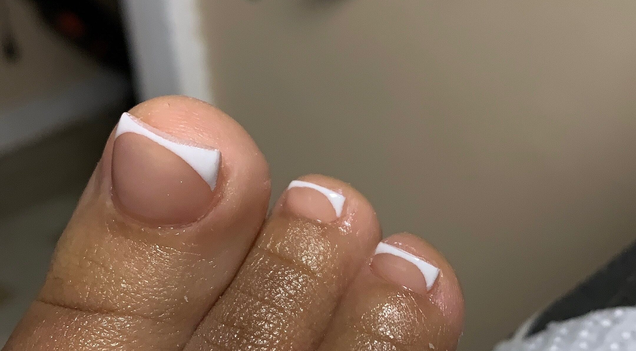 Close-up of a French pedicure at CLAWZ, Cape Town, Western Cape, ZA, showcasing neatly manicured toenails.