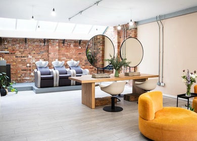 Modern interior of Boo.colourist - East London salon in London, England, GB with stylish seating and mirrors.