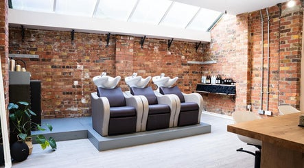 Chic wash station at Boo.colourist - East London, adorned with rustic brick walls in London, England, GB.