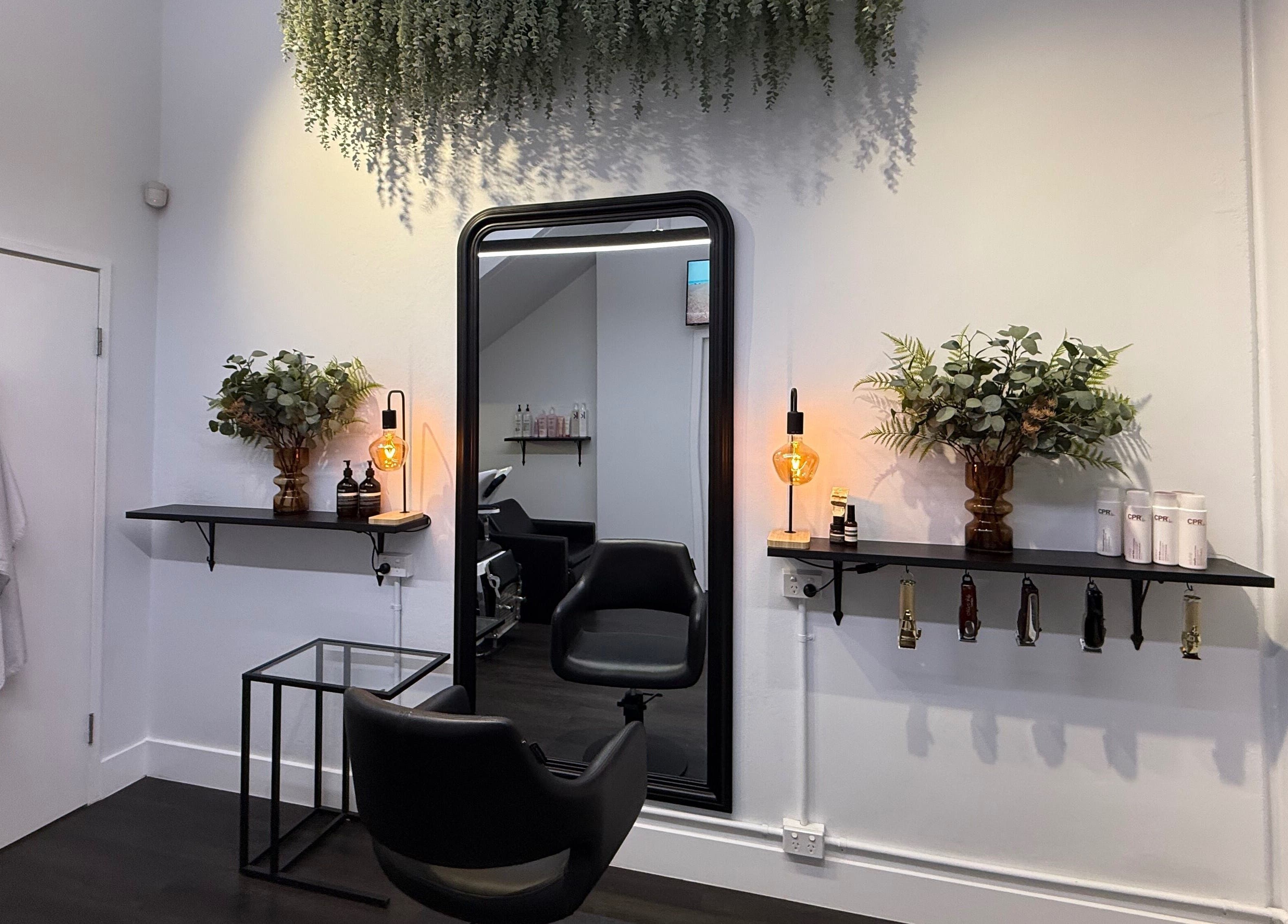 Chic salon setup at St Louis and Co, Kingsgrove, New South Wales, AU, featuring a stylish mirror and greenery.