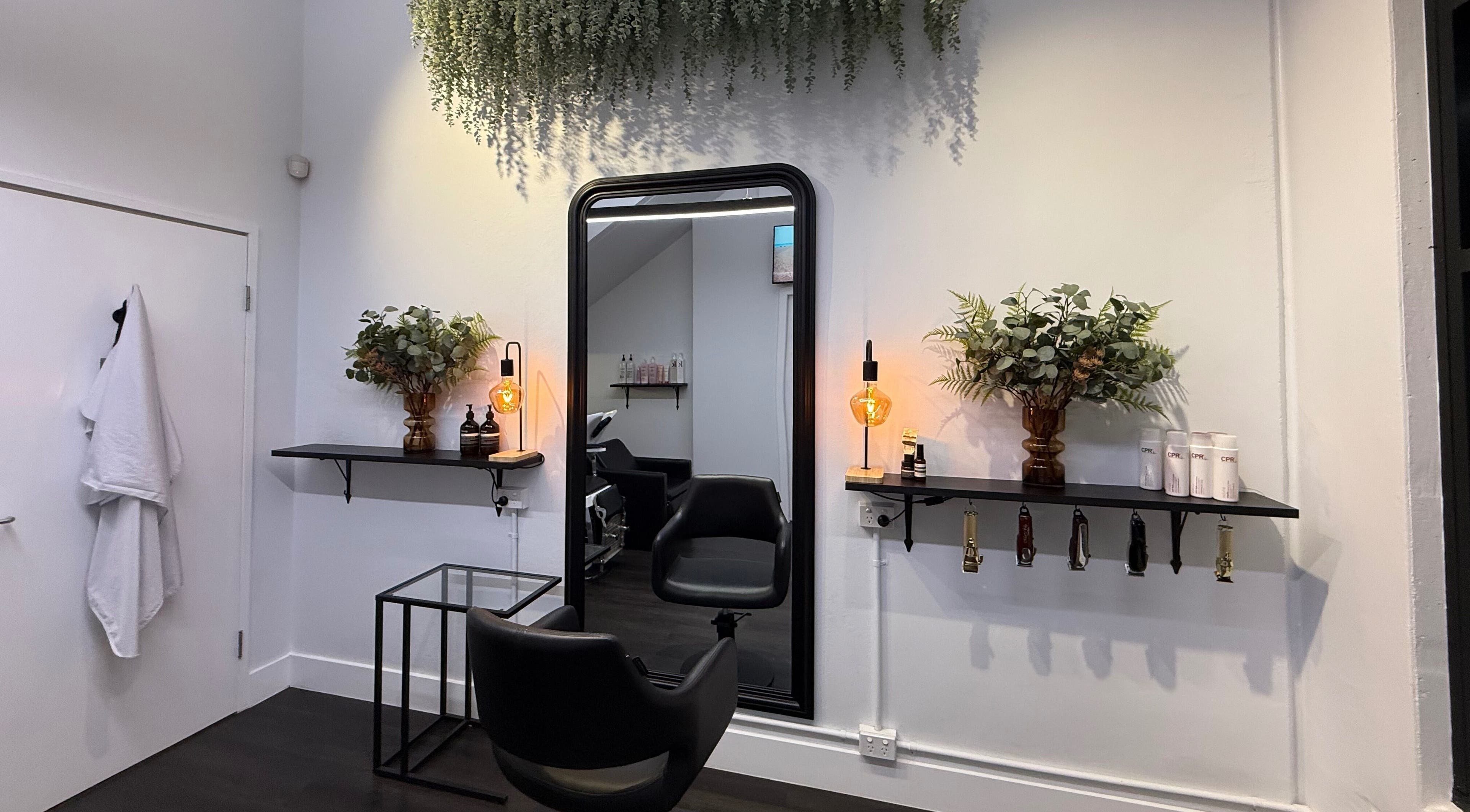 Chic salon setup at St Louis and Co, Kingsgrove, New South Wales, AU, featuring a stylish mirror and greenery.