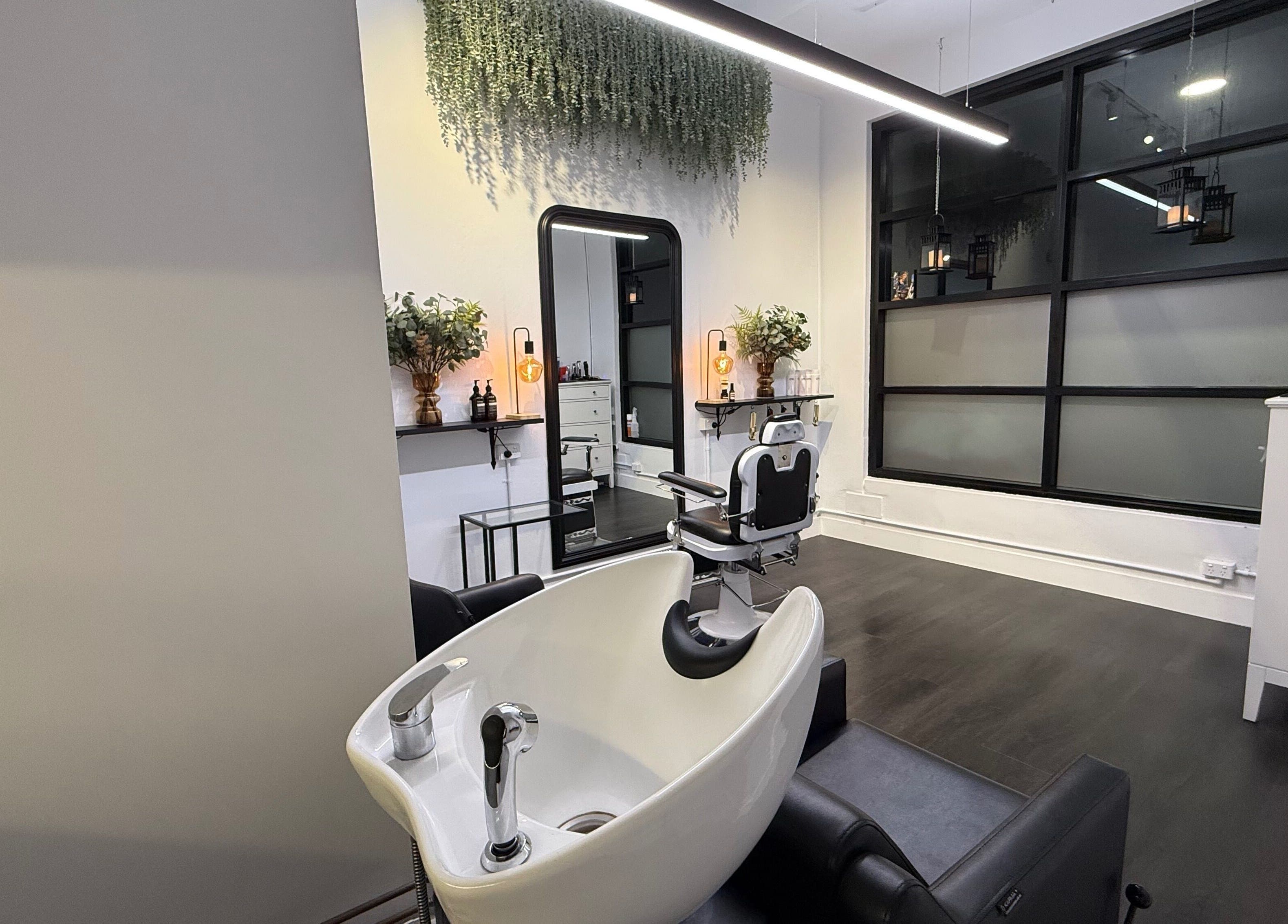 Modern salon interior at St Louis and Co, Kingsgrove, New South Wales, AU featuring styling chair and basin.