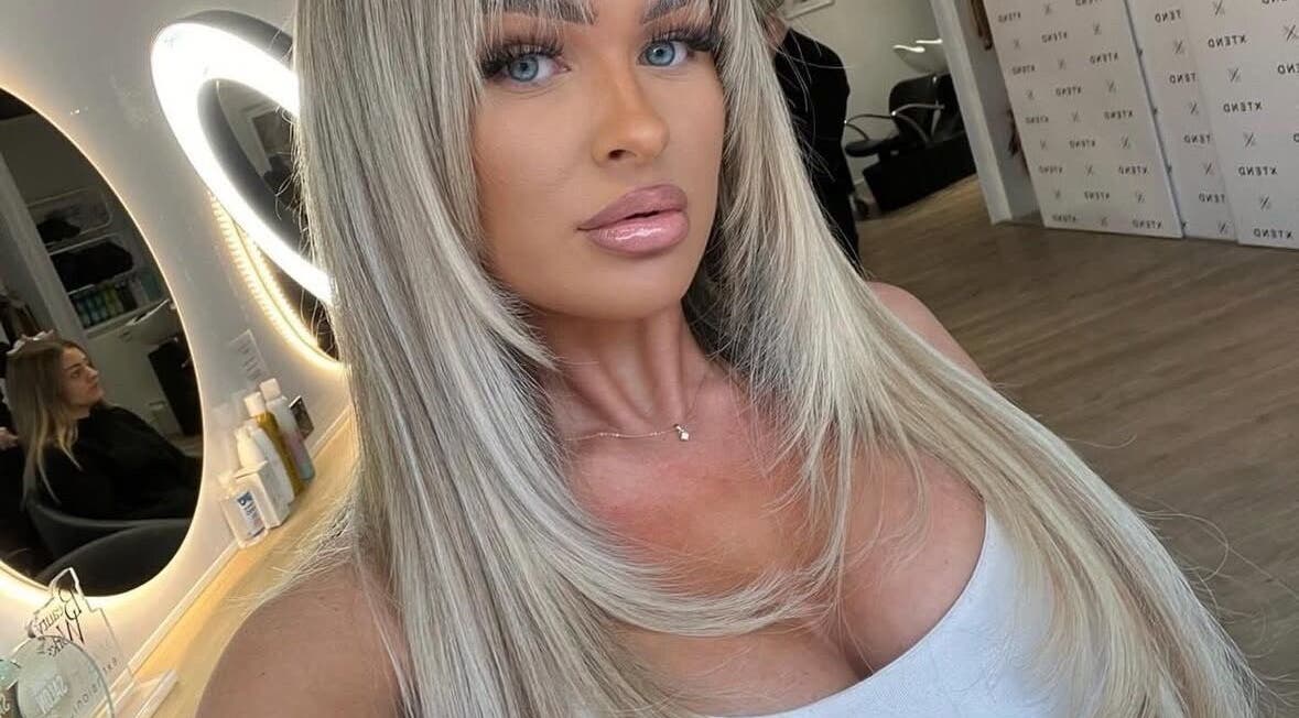 A stylish woman in a salon at XTEND With Style, Fareham, England, GB with a luminous mirror reflection.