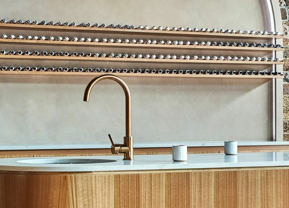 Sleek wooden counter and faucet at Ella&Jade Woolloongabba, Queensland, AU. Modern beauty salon interior.