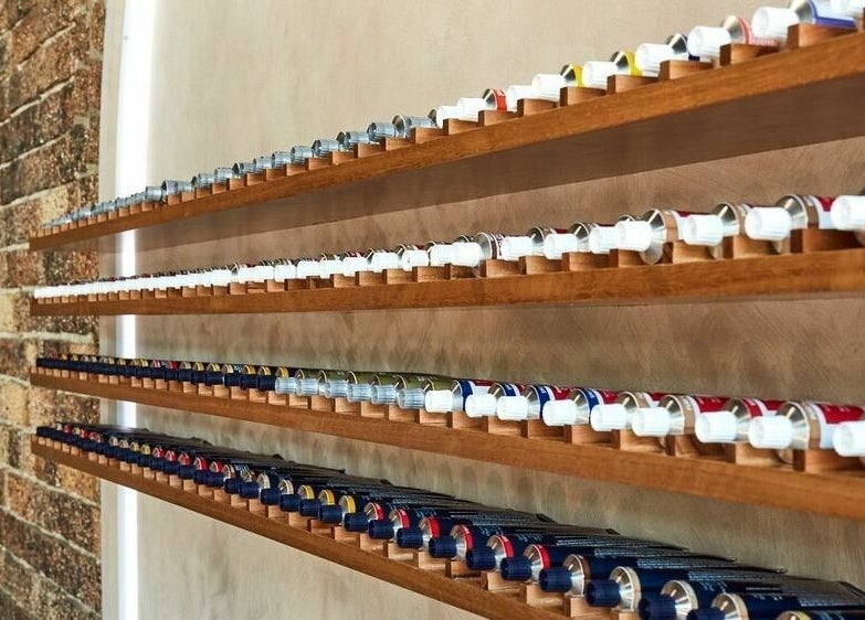 Ella&Jade Woolloongabba's vibrant hair color selection displayed on wooden shelves in Woolloongabba, Queensland, AU.