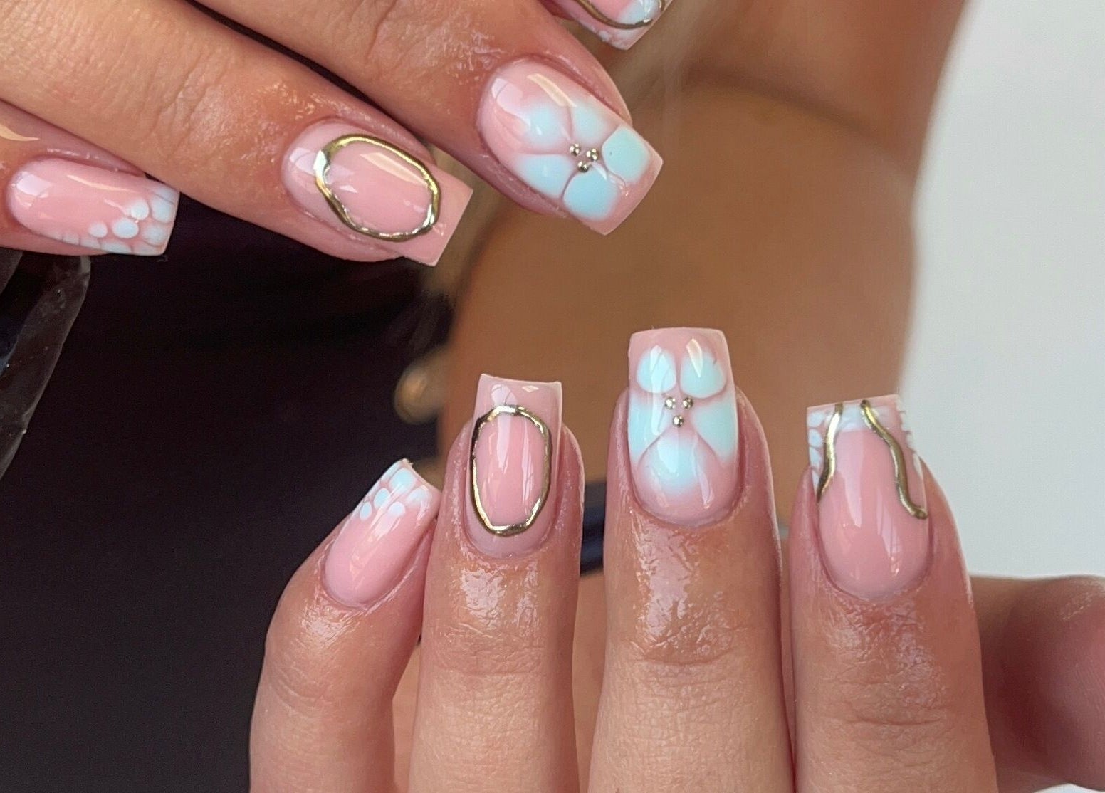 Chic pink nail art at Gels by Grace in Sunderland, England, GB showcases floral and metallic designs.