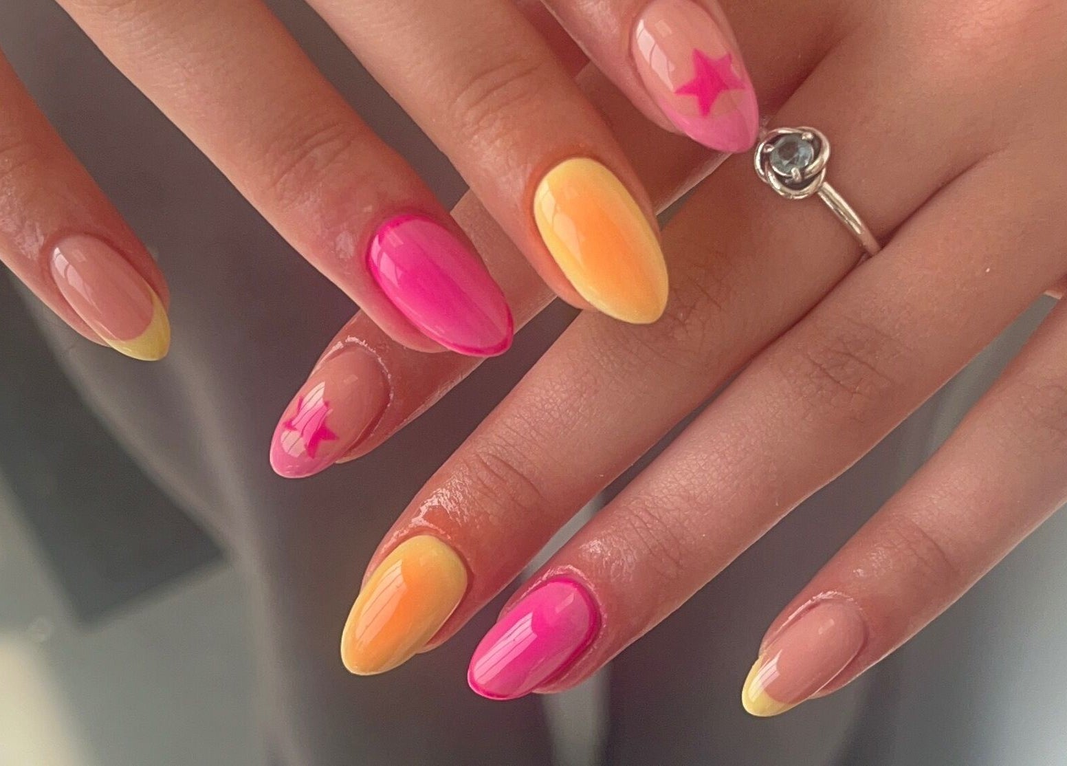 Vibrant sunset-themed nails at Gels by Grace, Sunderland, England, GB. Stylish ombre with star accents.