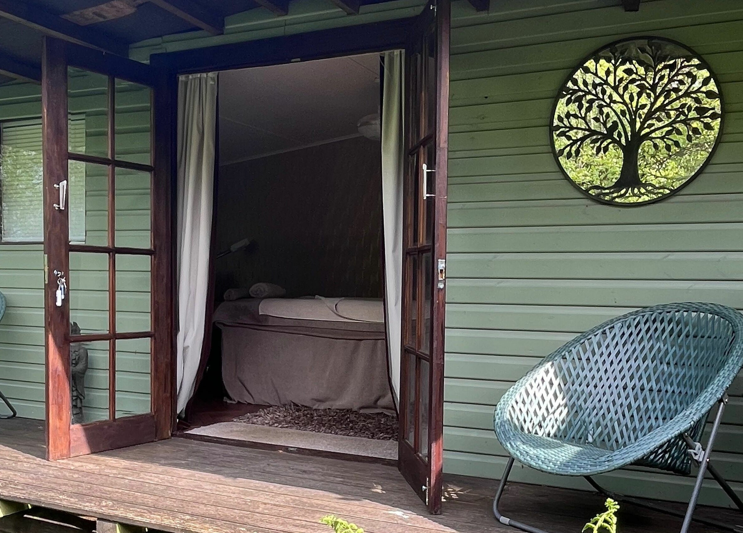 Relaxing treatment room at Tranquility Treatment Room in Whitworth, England with open doors and nature views.