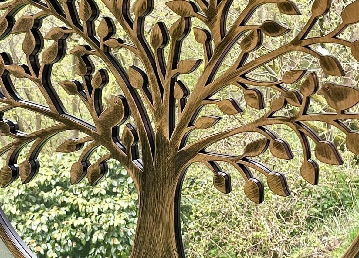 Intricate tree mirror in Tranquility Treatment Room, Whitworth, England, GB enhances ambiance with nature design.