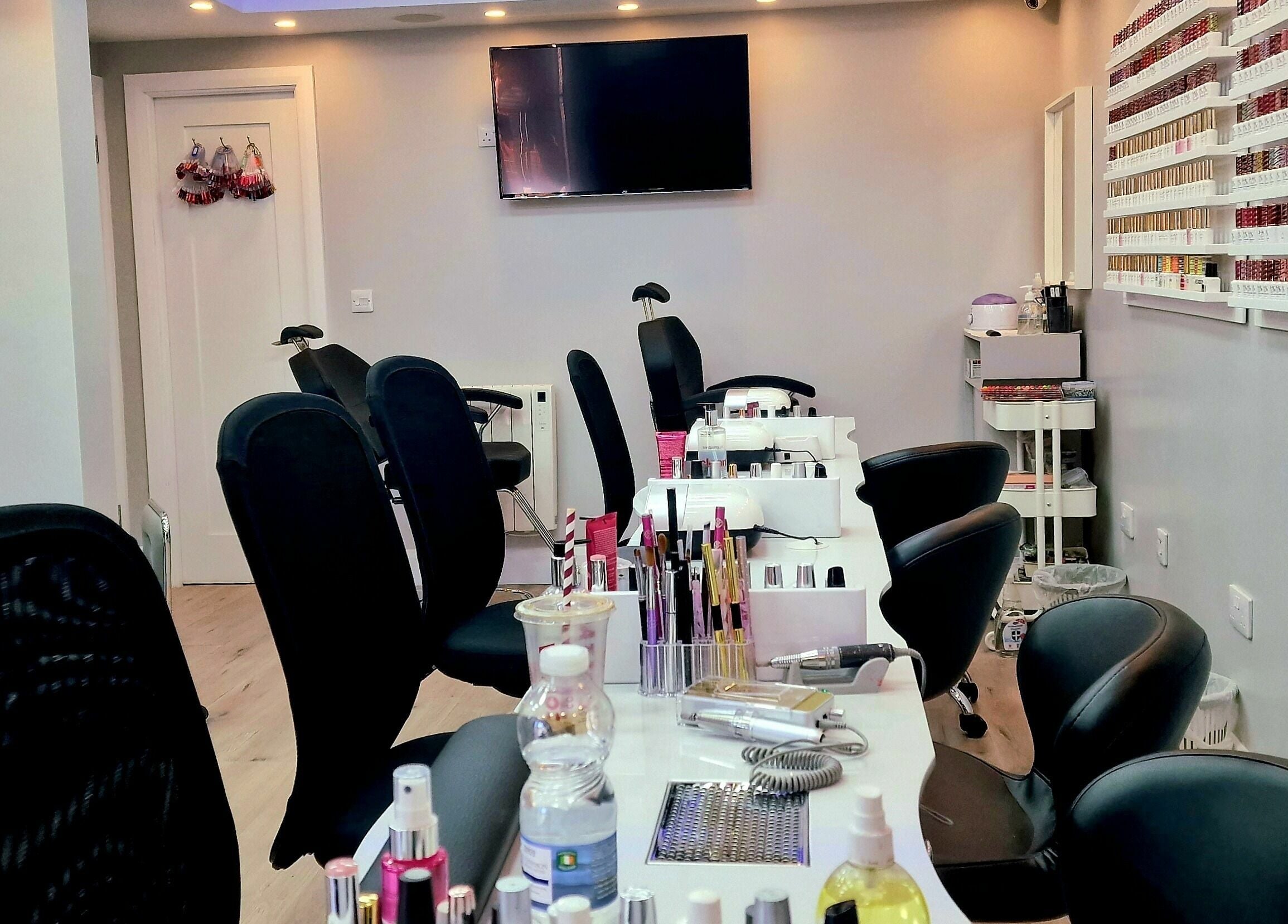 Modern nail service area at Kim.V Nails in Celbridge, County Kildare, IE with chic black chairs and nail polish display.