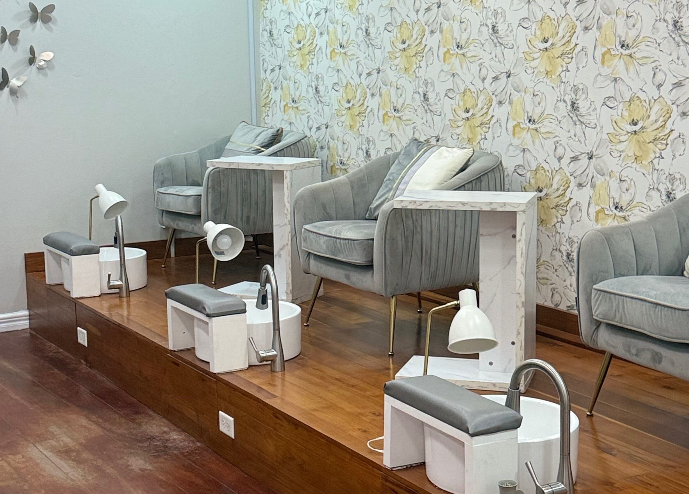 Luxurious pedicure area at Beaute Bomb by Natoya in Woodbrook, TT, featuring stylish seating and floral decor.
