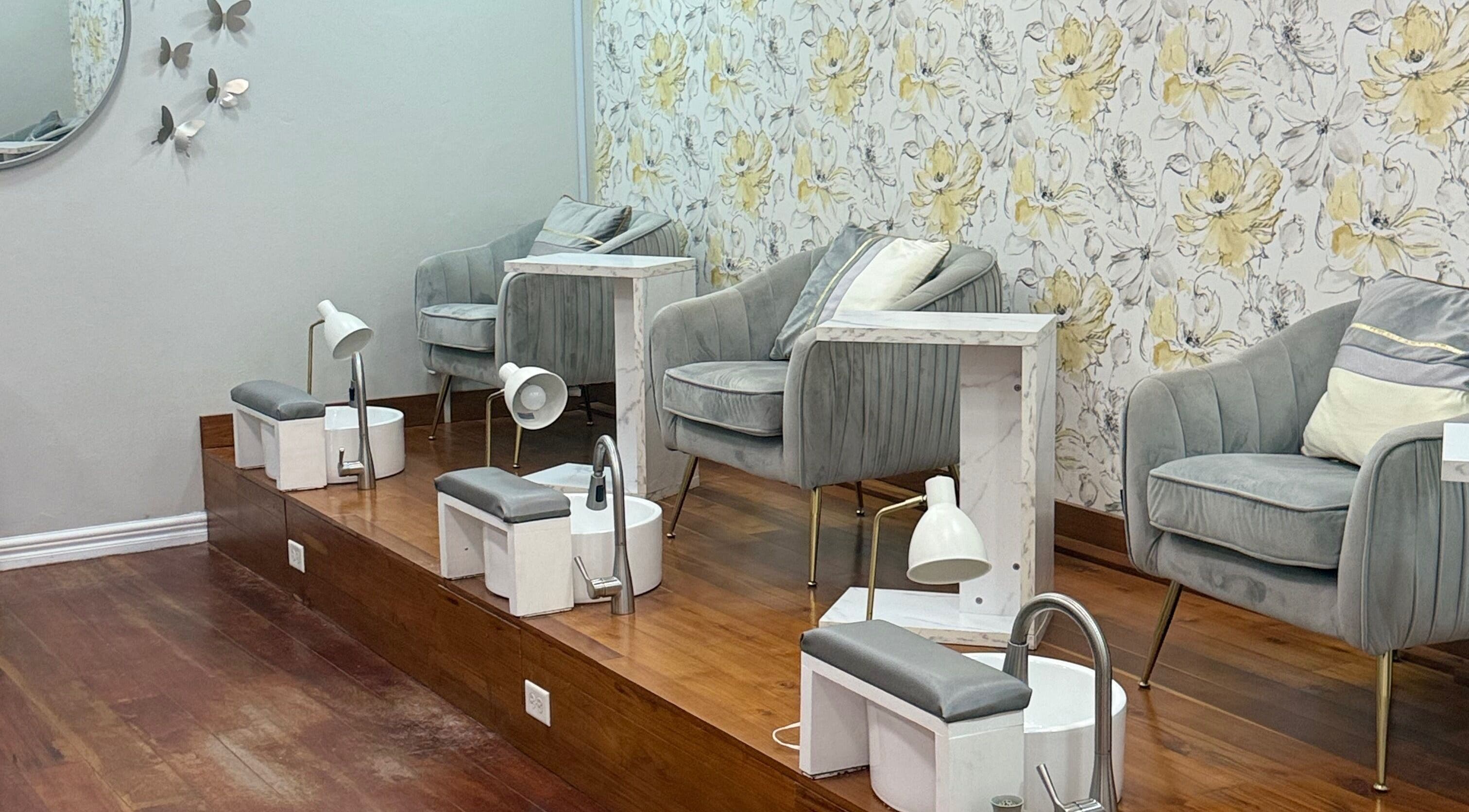 Luxurious pedicure area at Beaute Bomb by Natoya in Woodbrook, TT, featuring stylish seating and floral decor.